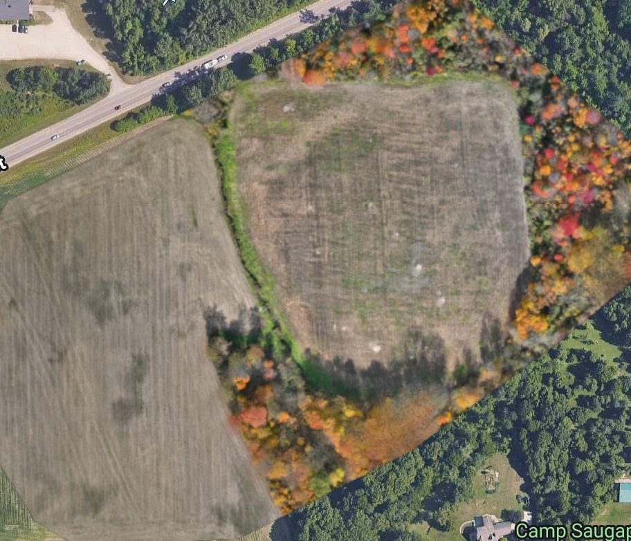 WEMAD photographic orthomosaic of two farm fields, a central vegetated divide, and wooded margins, with four numbered inspection pointers